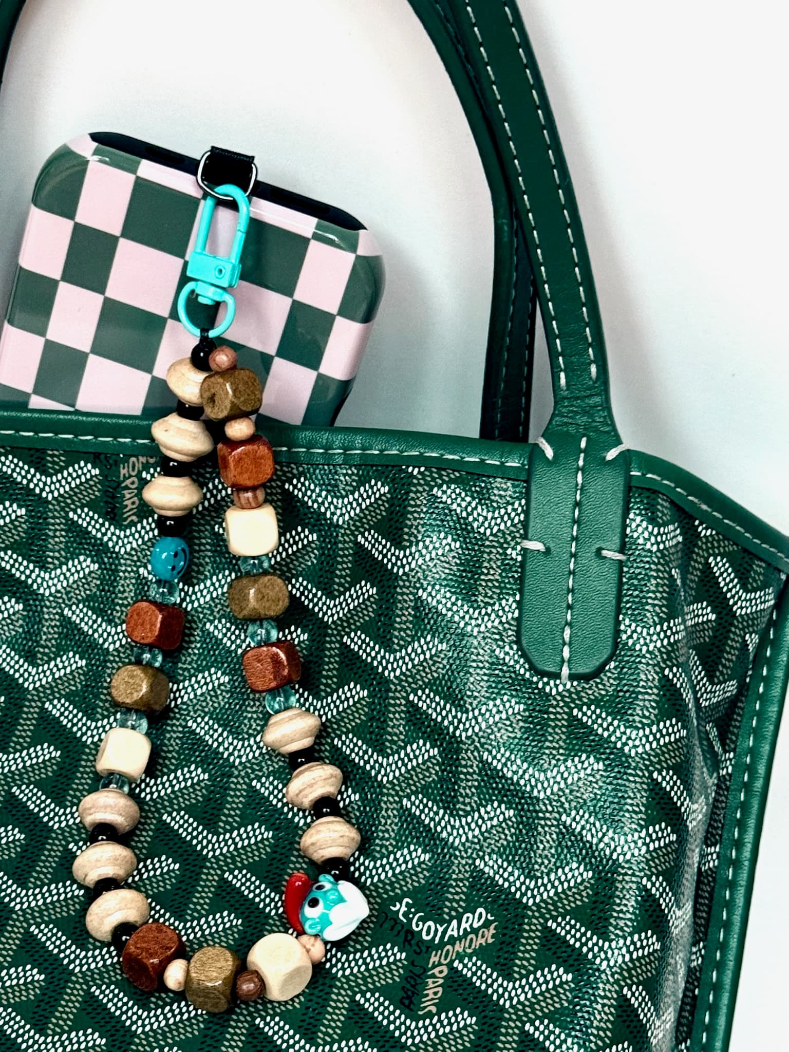 Hart Bead artisan charm on a luxury bag